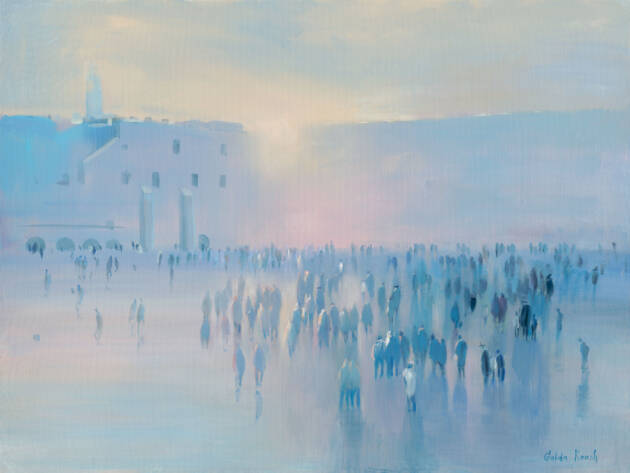 Crowd of people in Jerusalem, old city with sunrise behind tall building in background