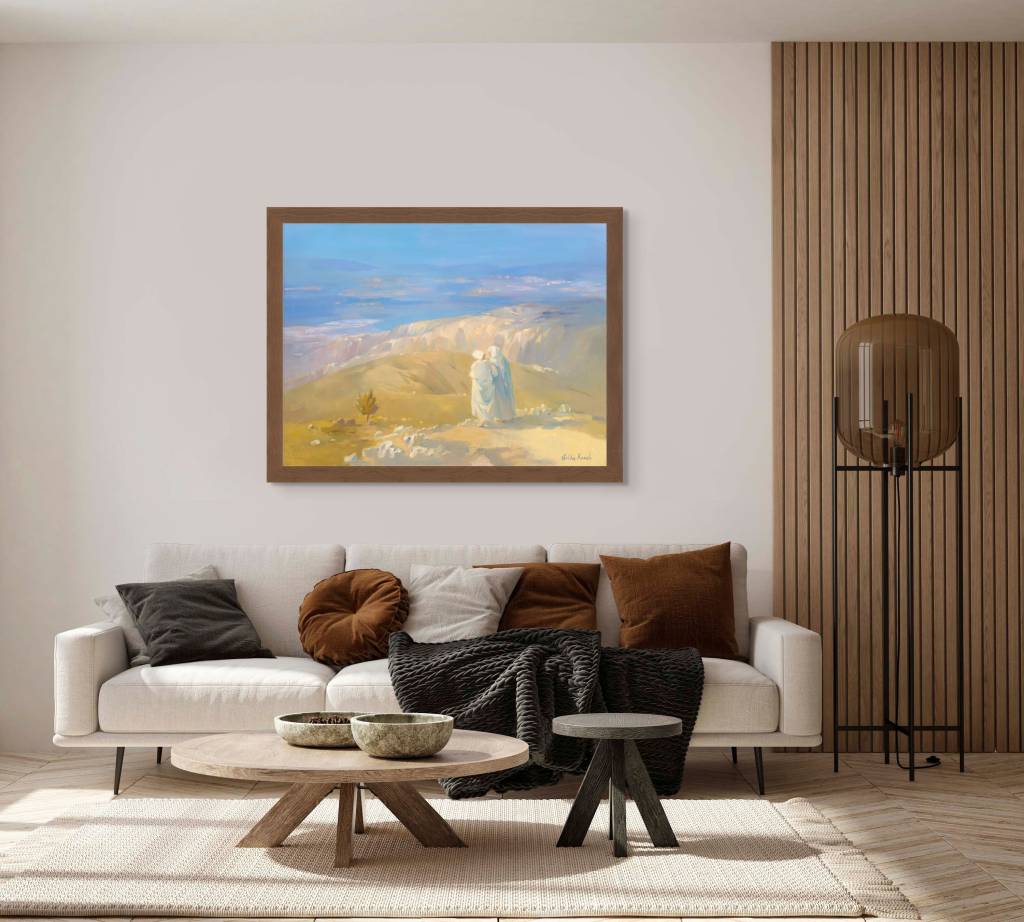 Mockup of "Naomi and Ruth Looking Towards a Bright Future" in a room with a coffee table and sofa behind it, the painting is hanging on a wall with a brown frame, whole room is coffee color themed