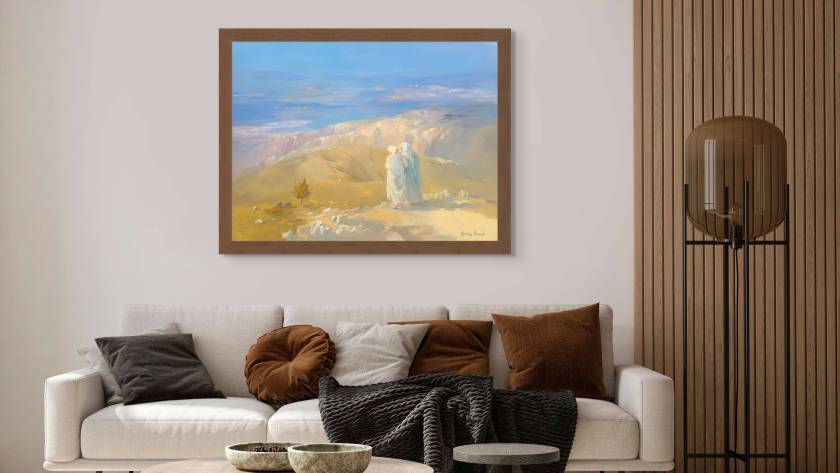 Mockup of "Naomi and Ruth Looking Towards a Bright Future" in a room with a coffee table and sofa behind it, the painting is hanging on a wall with a brown frame, whole room is coffee color themed